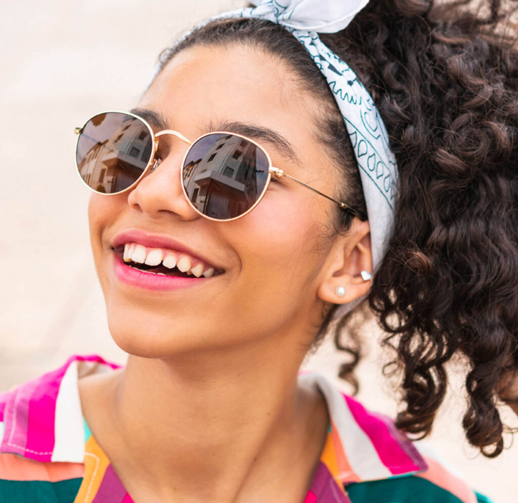 Young teen girl smiling with bandana around hair and sunglasses, braces for teens Greater Northwest Orthodontics